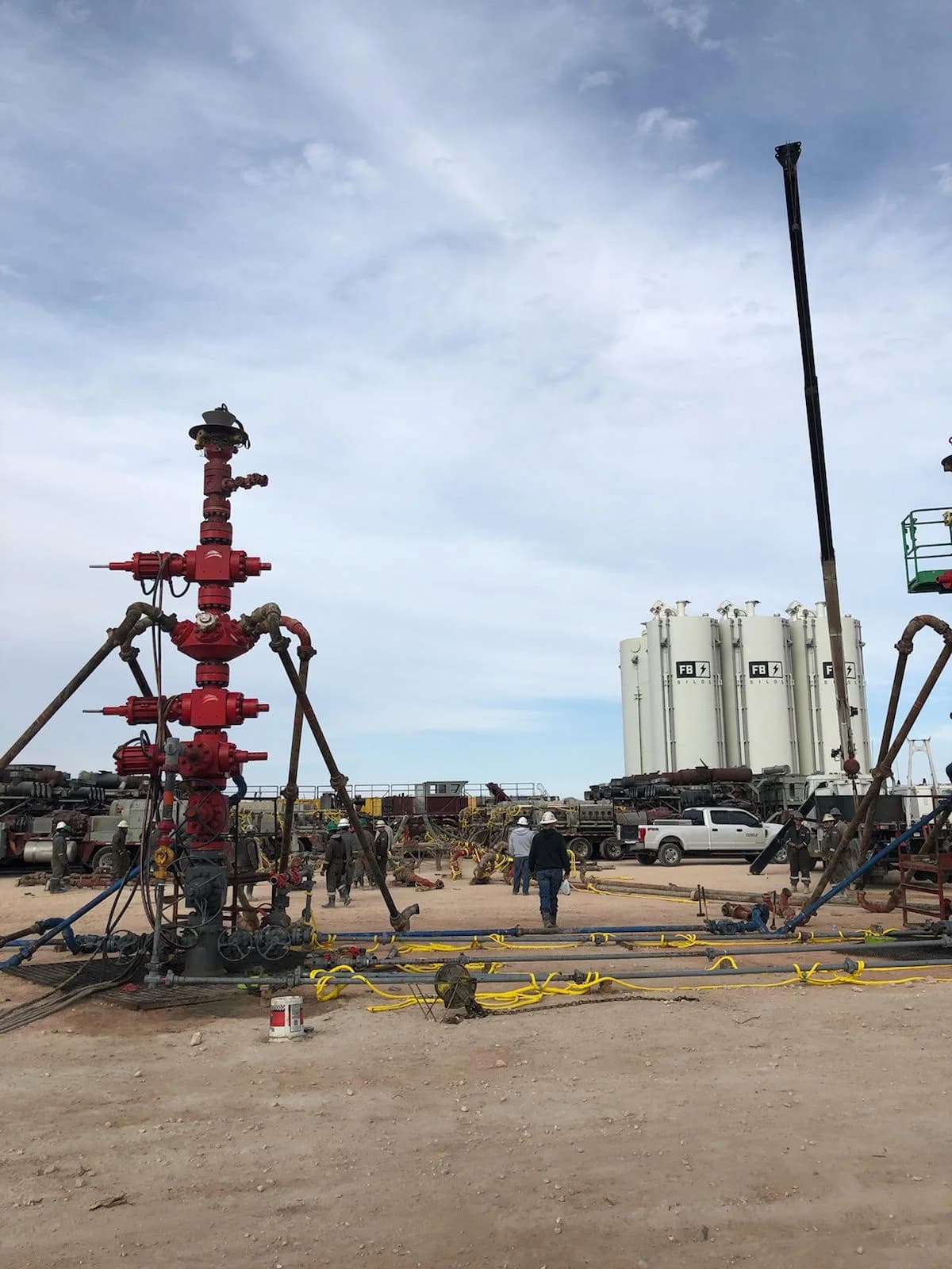 Wellhead equipment with storage silos in the background
